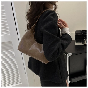 Detailed shot of dark brown vintage underarm bag with Fashion & Bags text on soft PU leather