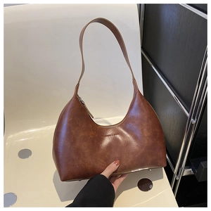 Close-up of vintage brown oil wax leather hobo bag featuring Fashion & Bags logo