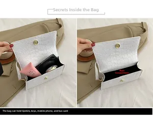 Detailed view of the white crocodile-embossed bag interior showing capacity for daily essentials