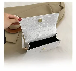 Internal view showing storage capacity of white crocodile pattern square crossbody bag