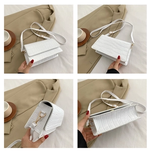 Multiple views of a white faux leather crocodile pattern shoulder bag with a metal buckle