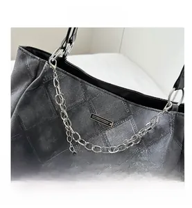 Close-up of luxury PU crossbody bag with checkered texture and silver metal chain strap