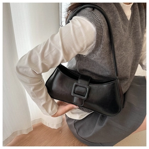 Close-up of black retro shoulder bag featuring a stylish wide strap with square buckle