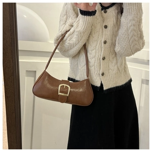 Brown retro baguette underarm bag featuring decorative belt strap and gold buckle