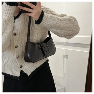 Chic dark coffee leather shoulder bag with decorative buckle shown in a mirror selfie style
