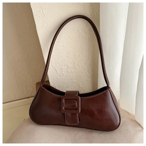 Detailed view of vintage dark brown faux leather underarm bag with square buckle strap