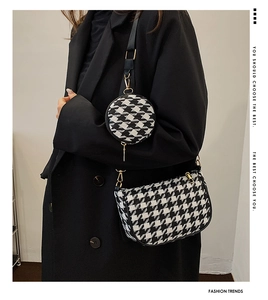 Detail of houndstooth crossbody bag set with gold hardware and removable round pouch