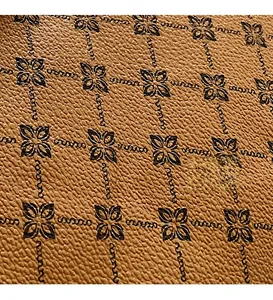 Close-up of vintage brown leather texture with floral pattern and soft chain print