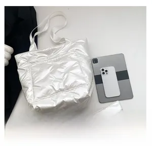 White quilted puffer tote bag set with matching pouch showing large capacity and tablet