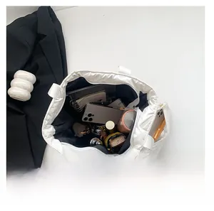 Top view of white padded tote bag interior showing large capacity for daily items