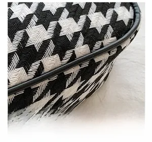 Close-up of houndstooth pattern fabric with high-quality precision stitching details