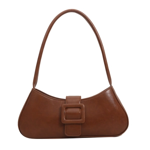 Vintage brown leather baguette shoulder bag with large square buckle on white background