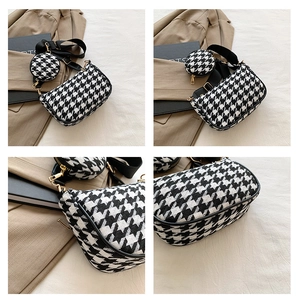 Detail of houndstooth crossbody bag with round coin purse and wide nylon strap