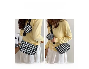 Detail showing houndstooth shoulder bag with adjustable strap and small coin purse