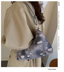 Detail of grey nylon shoulder bag with colorful cloud and star prints for daily commute