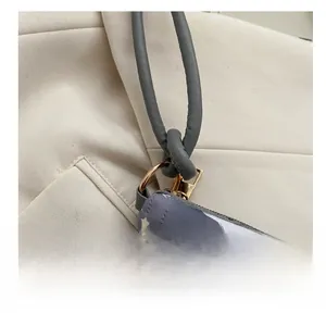 Detail of quilted shoulder bag with rainbow and star prints and golden metal zip