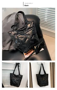 Detail of black quilted down-filled bucket bag with matching mini zip pouch accessory