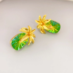 Detail of tropical pineapple studs with green crystals and gold palm tree tops