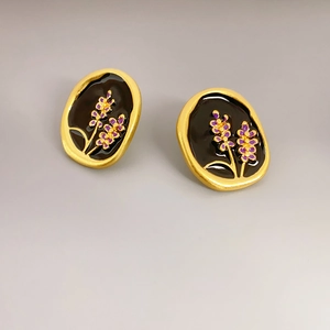 French vintage lavender enamel stud earrings with matte gold finish on a gray base
