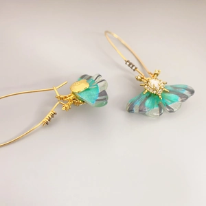 Elegant gold butterfly earrings with blue-green gradient resin wings and zircon accents