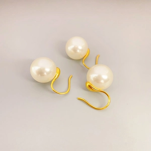 Elegant 925 silver pearl drop earrings with 18K gold hooks shown on a grey surface