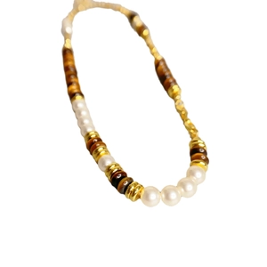 Retro beaded necklace featuring white pearls, gold metal beads, and tiger eye stones