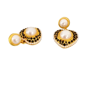 Elegant gold heart earrings with white pearls and black zircon inlay on a white background