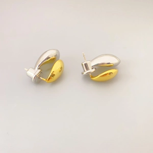 Minimalist gold and silver two-tone bean stud earrings with luxury polished finish