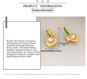 Detail of gold heart earrings with pink stone and dimensions shown in size chart