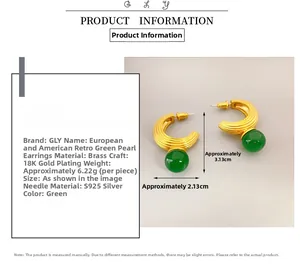 Macro view of C-shaped 18K gold plated earrings featuring green agate stone inlay