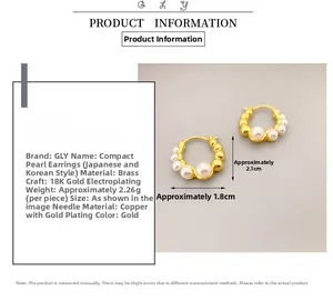 Detail view of gold-plated hoop earrings with inlaid white pearls and dimensions