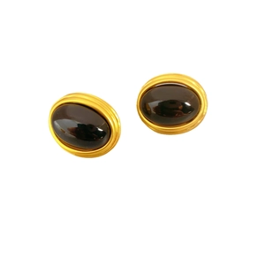 Vintage oval gold-toned earrings with spiral texture and black gemstone center
