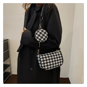Detail view of houndstooth crossbody bag set with gold hardware and small round pouch