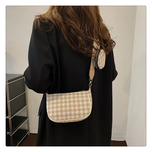 Chic houndstooth pattern crossbody bag set with wide strap shown on a model