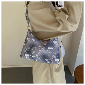 Detail of gray quilted nylon shoulder bag with colorful rainbow and cloud pattern embroidery