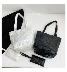Detail view of puffer tote bag set with quilted diamond pattern and matching mini pouches