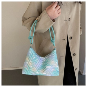 Detail of mint gradient quilted nylon bag with cloud prints and knotted handle