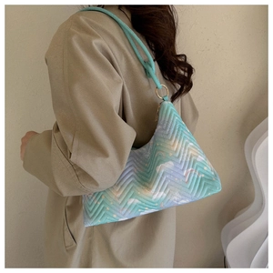 Detail of the quilted pattern with butterfly and rainbow prints on the gradient nylon bag