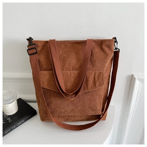 Brown corduroy tote bag with front pocket and adjustable strap for daily commuting