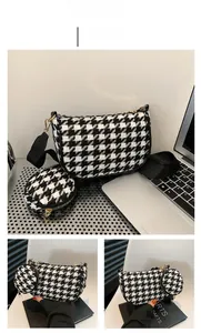 Detail of houndstooth underarm bag with small coin purse and black fabric shoulder strap