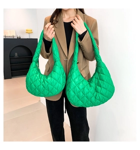 Size comparison of green quilted tote bags showing large and small puffer shoulder bags