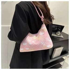 Detail of pink gradient nylon bag with V-quilting and butterfly prints on a model
