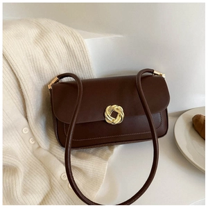 Minimalist brown retro shoulder bag with a gold round buckle on a white background