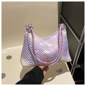 Detail of crescent shoulder bag with V-quilt pattern and pastel cloud star motifs
