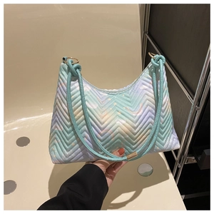 Detail of V-shaped quilted nylon bag with pastel macaron gradient and gold ring hardware