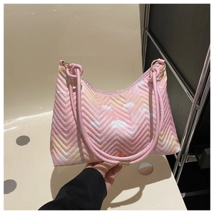 Detail of pink gradient nylon tote with V-quilted pattern and butterfly cloud prints