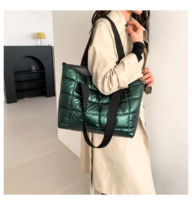 Close-up of metallic green quilted tote bag with large capacity and soft padding