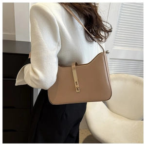 Detail view of khaki leather underarm bag with gold metallic buckle and elegant curved shape