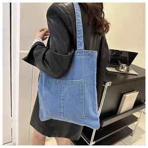 Light blue denim tote bag with front pockets for women, casual daily commuter style