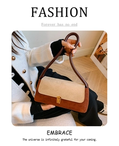 Detail of vintage contrast underarm bag with gold metal clasp and premium suede texture